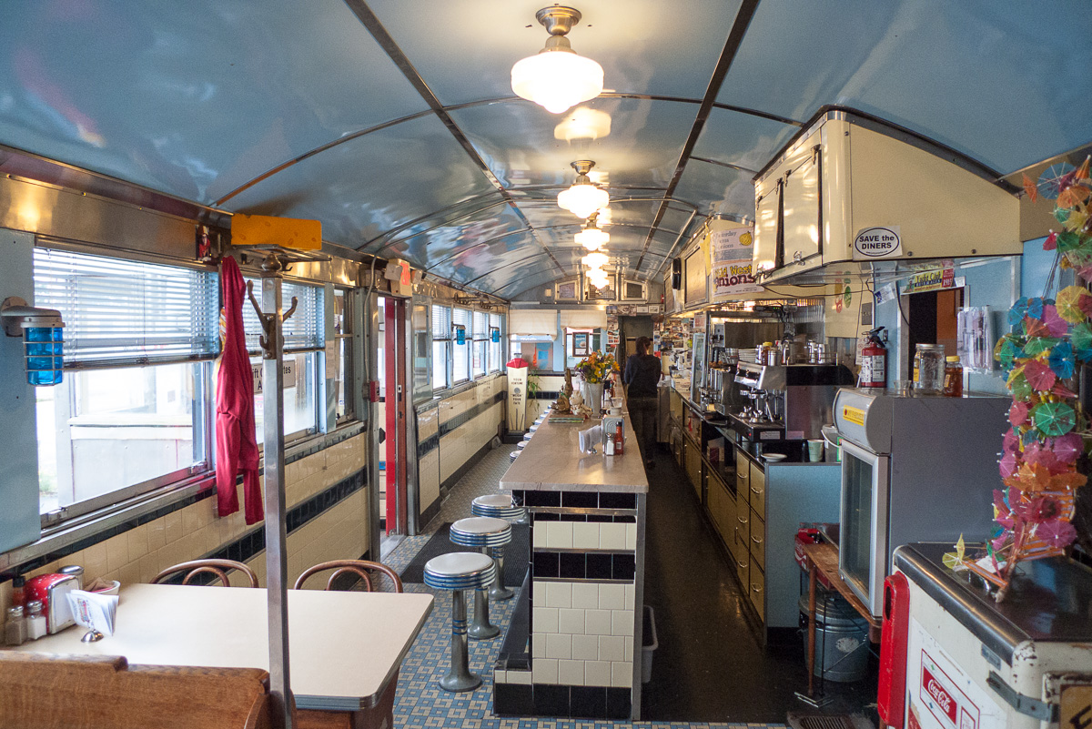 The counter and booths of a classic neighborhood diner.